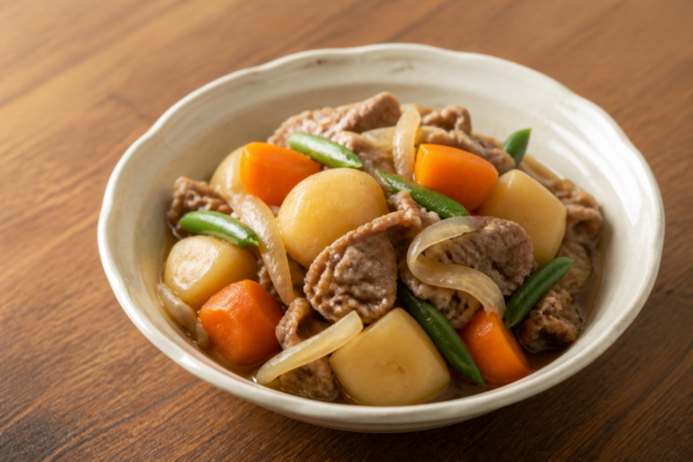 Finished Japanese nikujaga with beef, potatoes, carrots, onions and green beans