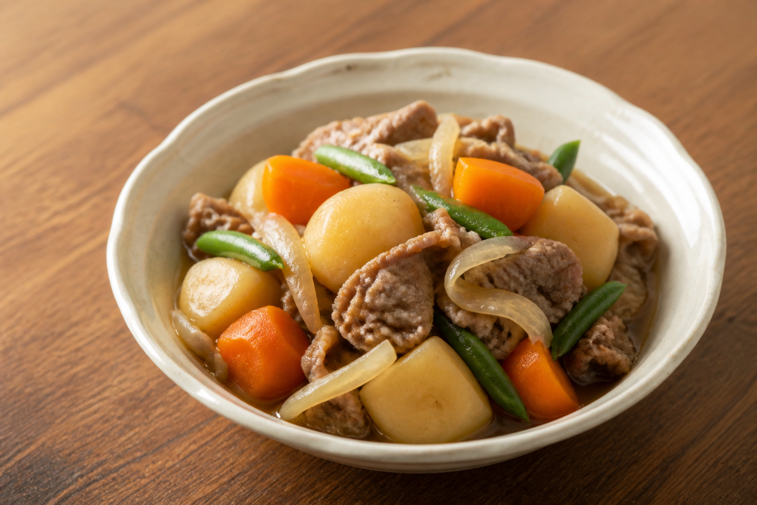 Finished Japanese nikujaga with beef, potatoes, carrots, onions and green beans