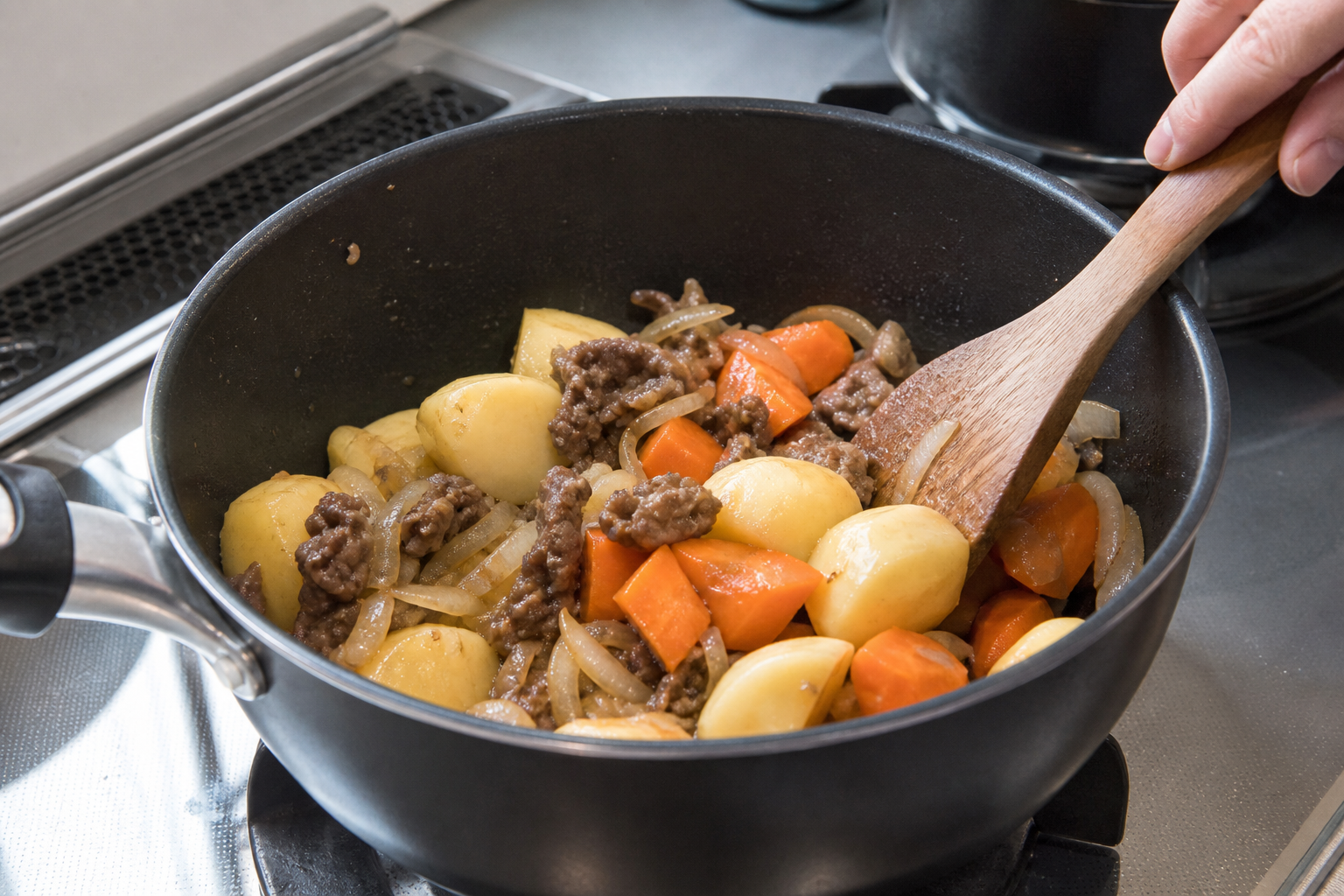 Potatoes and carrots added to browned beef and onions for nikujaga